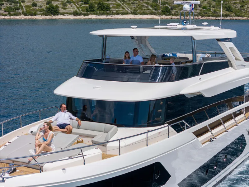 Slide: The Image of Luxury 2024 Absolute NAVETTA 75 yacht cruising with passengers on deck. - 11