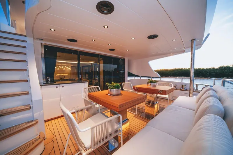Slide: The Image of Luxurious 2020 Benetti Delfino 95 yacht deck with elegant seating and dining area. - 13