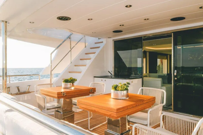 Slide: The Image of Luxurious Benetti Delfino 95 yacht deck with elegant seating, 2020 model. - 15