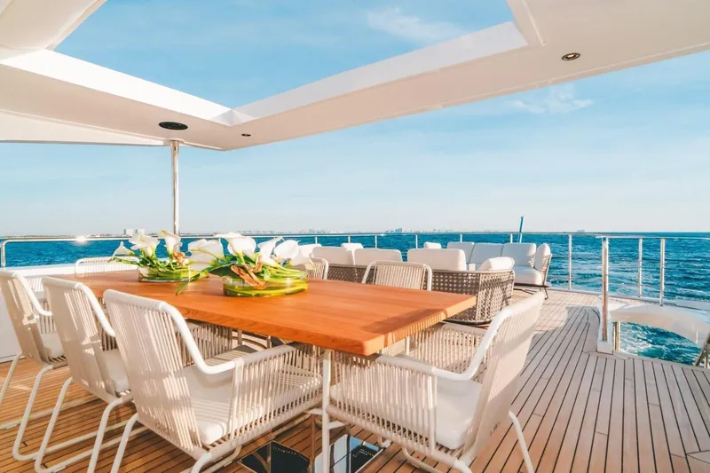 Slide: The Image of Luxurious Benetti Delfino 95 yacht deck with elegant dining area, ocean view, 2020 model. - 24