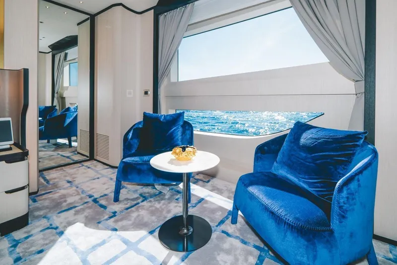 Slide: The Image of Luxurious interior of 2020 Benetti Delfino 95 yacht with ocean view and blue seating. - 36