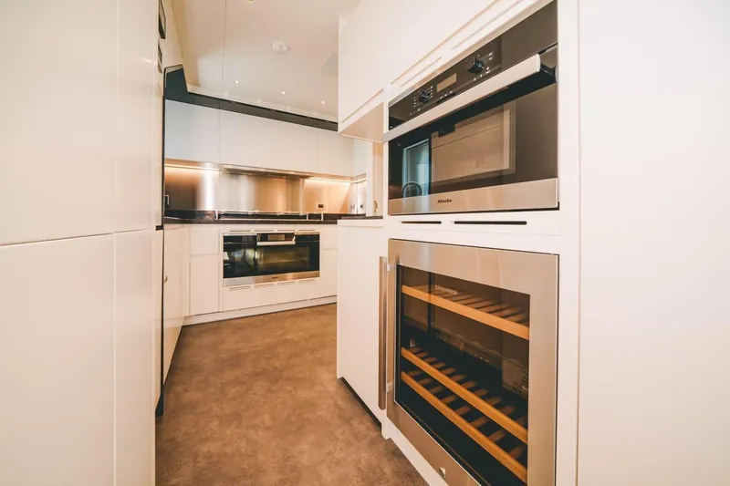 Slide: The Image of Modern kitchen interior on 2020 Benetti Delfino 95 yacht, featuring sleek appliances and cabinetry. - 47