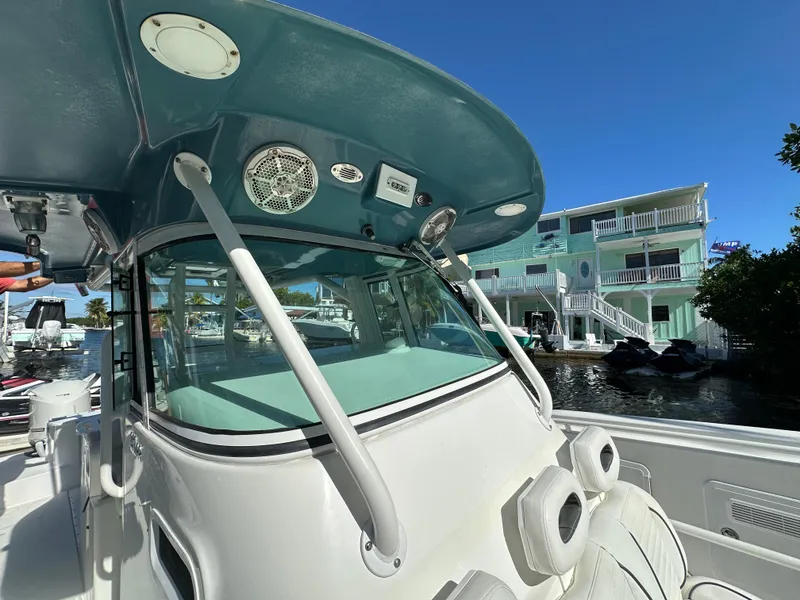 Slide: The Image of 2008 Everglades 350 CC boat docked near waterfront homes. - 10