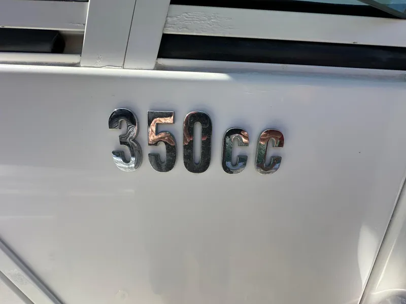 Slide: The Image of Everglades 350 CC boat emblem, 2008 model, metallic lettering on white surface. - 11