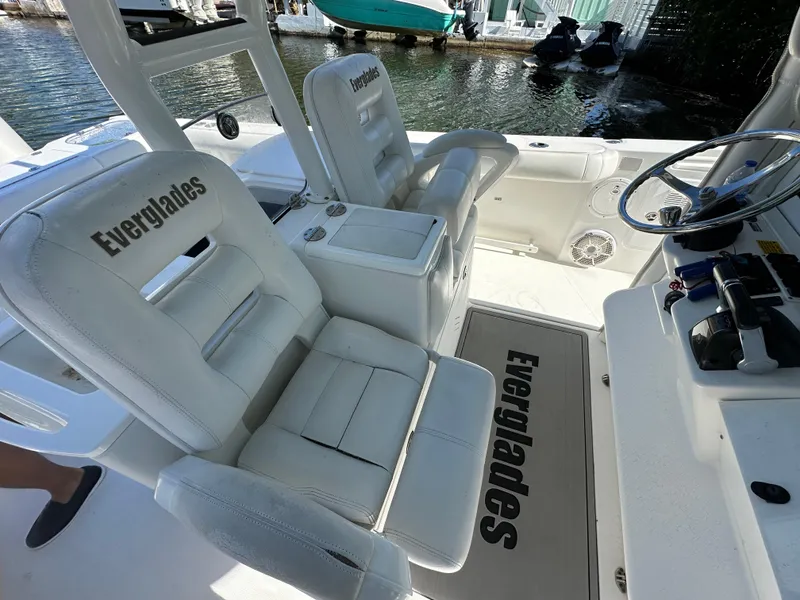 Slide: The Image of 2008 Everglades 350 CC boat interior with white seating and steering wheel. - 16