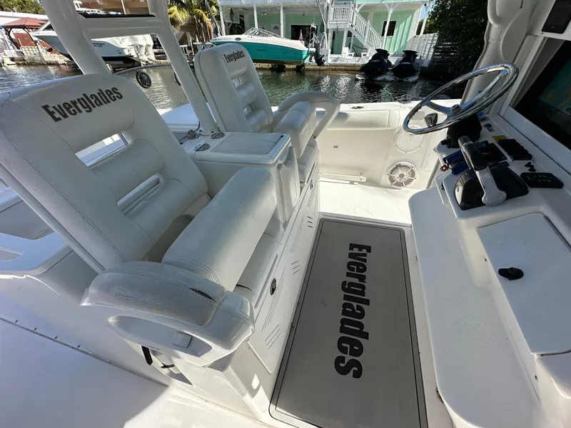 Slide: The Image of 2008 Everglades 350 CC boat interior with white seating and steering area. - 17