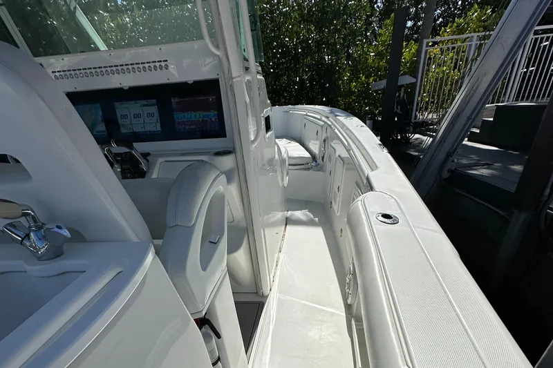 Slide: The Image of 2008 Everglades 350 CC boat interior with sleek white seating and modern controls. - 31