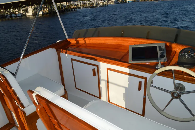 Slide: The Image of 1990 Stanley Downeast Lobster Boat's flybridge with wooden accents and navigational equipment. - 10