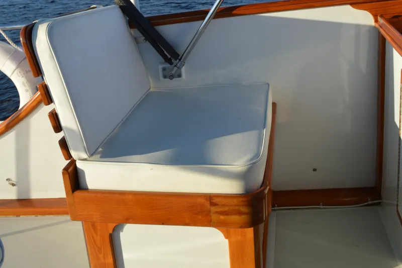 Slide: The Image of Wooden seat with white cushion on 1990 Stanley Downeast Lobster Yacht. - 12