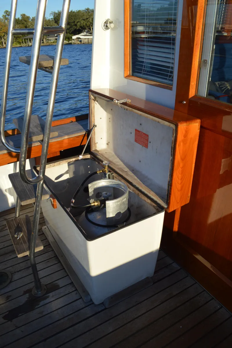 Slide: The Image of 1990 Stanley Downeast Lobster Boat with open storage compartment on deck, near water. - 20