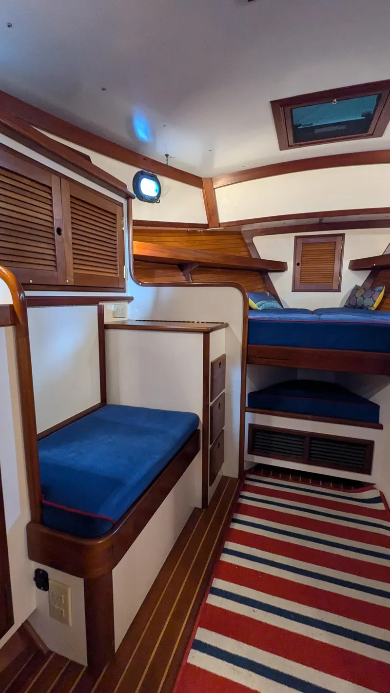 Slide: The Image of Interior of 1990 Stanley Downeast Lobster Yacht with blue seating and striped rug. - 23