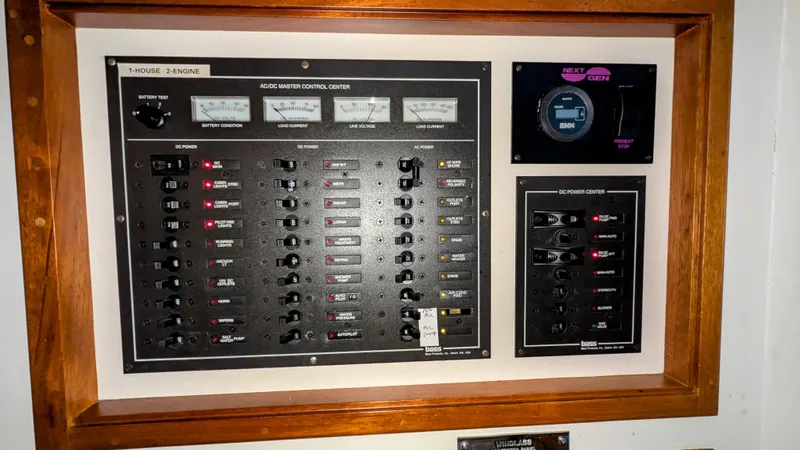 Slide: The Image of Electrical control panel on a 1990 Stanley Downeast Lobster Boat, featuring switches and gauges. - 34