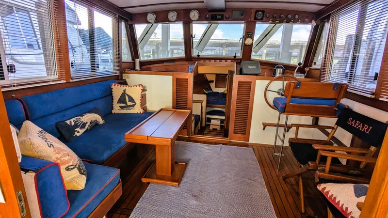 Slide: The Image of Interior of a 1990 Stanley Downeast Lobster Yacht with blue seating and nautical decor. - 37