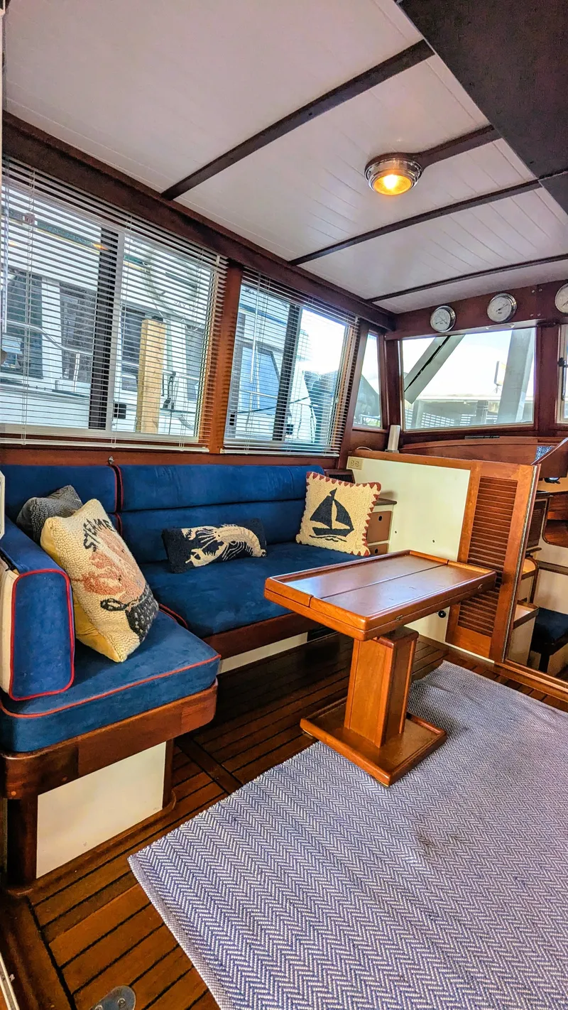 Slide: The Image of Interior of 1990 Stanley Downeast Lobster Yacht with blue seating and nautical decor. - 38