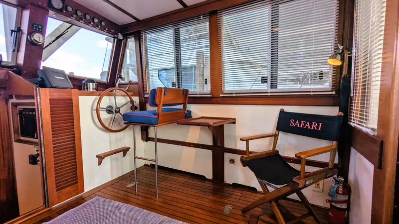 Slide: The Image of 1990 Stanley Downeast Lobster Boat interior with wooden helm, seating, and "Safari" chair. - 39