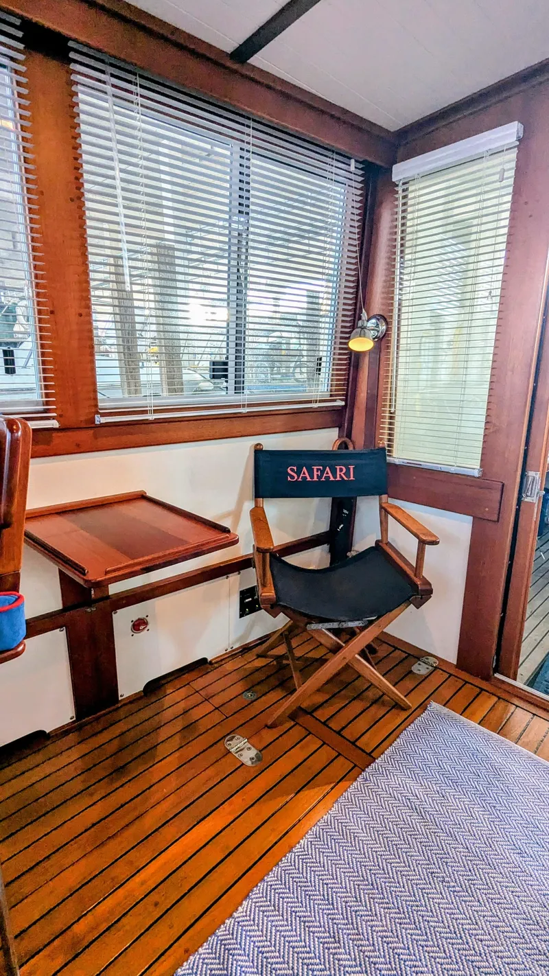 Slide: The Image of Interior of 1990 Stanley Downeast Lobster Yacht with wooden flooring and director's chair. - 40