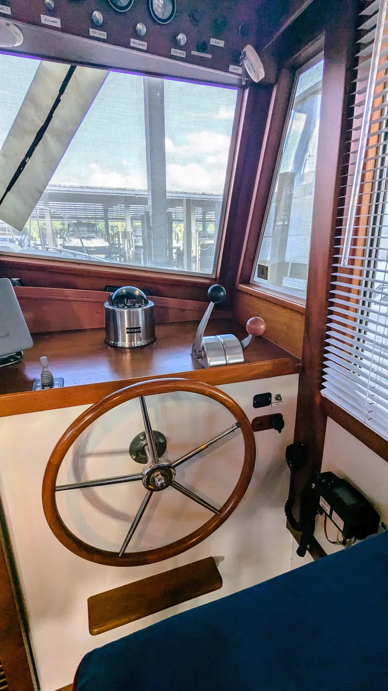 Slide: The Image of Interior of 1990 Stanley Downeast Lobster Boat with wooden steering wheel and controls. - 42