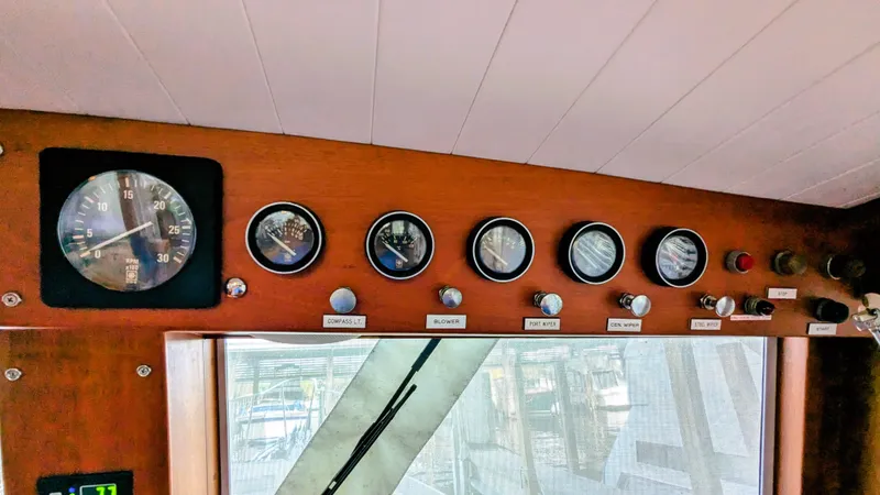 Slide: The Image of Control panel of a 1990 Stanley Downeast Lobster Boat with gauges and switches. - 43