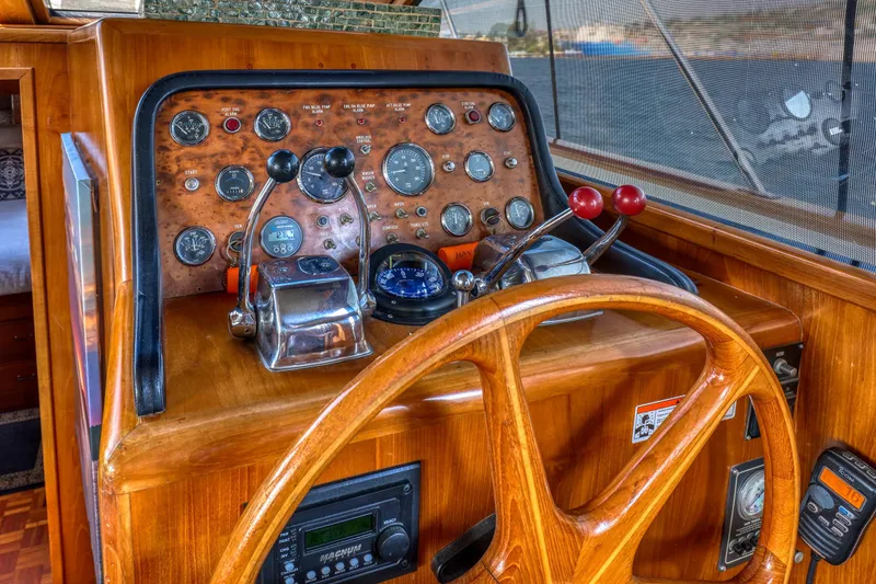 Slide: The Image of 1987 Ocean Alexander Motoryacht helm with wooden wheel and classic instrument panel. - 12