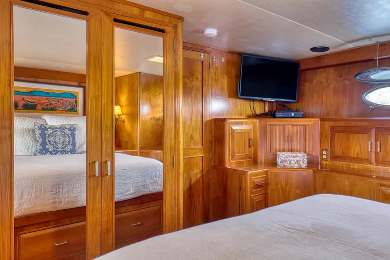 Slide: The Image of Luxurious 1987 Ocean Alexander Motoryacht bedroom with wood paneling and modern amenities. - 14