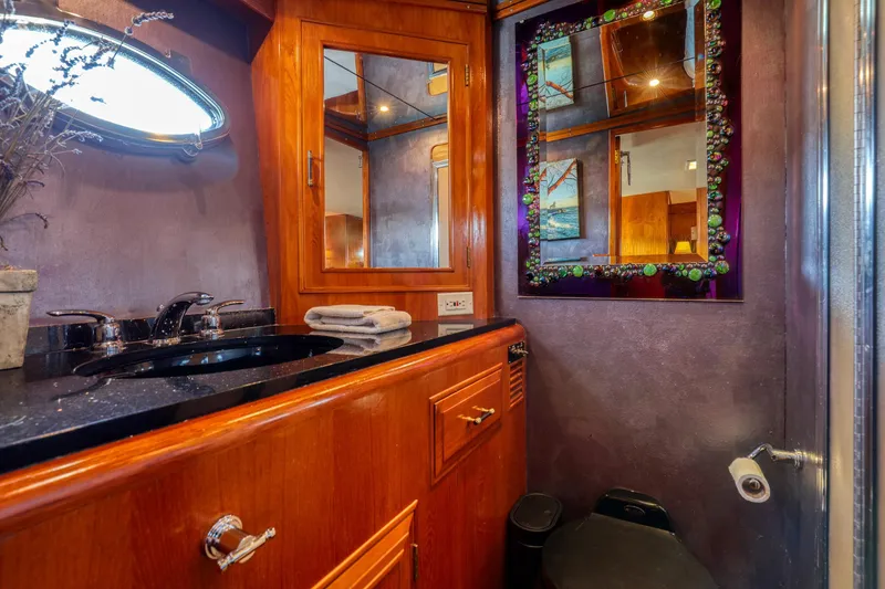 Slide: The Image of Luxurious 1987 Ocean Alexander Motoryacht bathroom with elegant wood cabinetry and decorative mirror. - 15