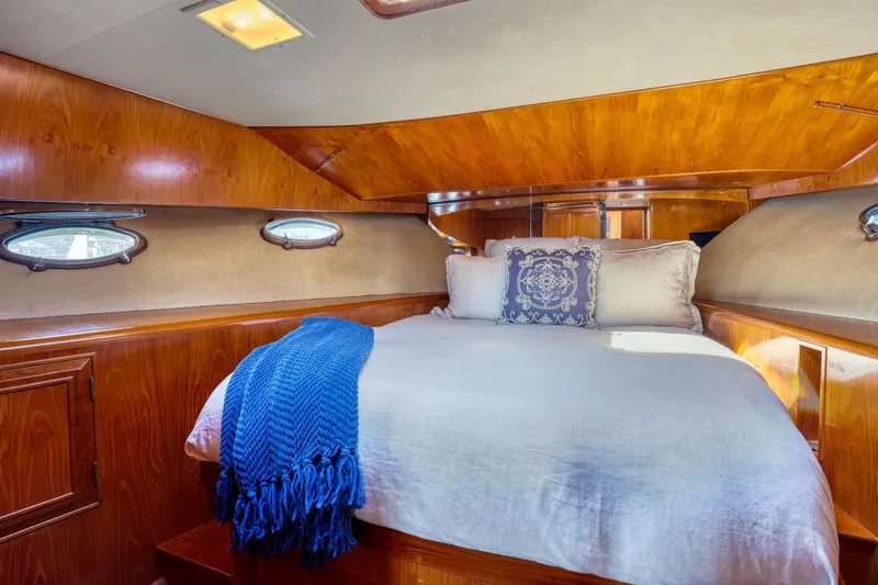 Slide: The Image of Luxurious 1987 Ocean Alexander Motoryacht cabin with cozy bed and elegant wood paneling. - 16