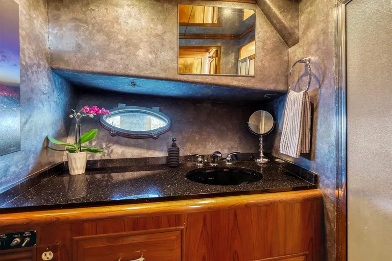Slide: The Image of Luxurious 1987 Ocean Alexander Motoryacht bathroom with elegant vanity and porthole window. - 17