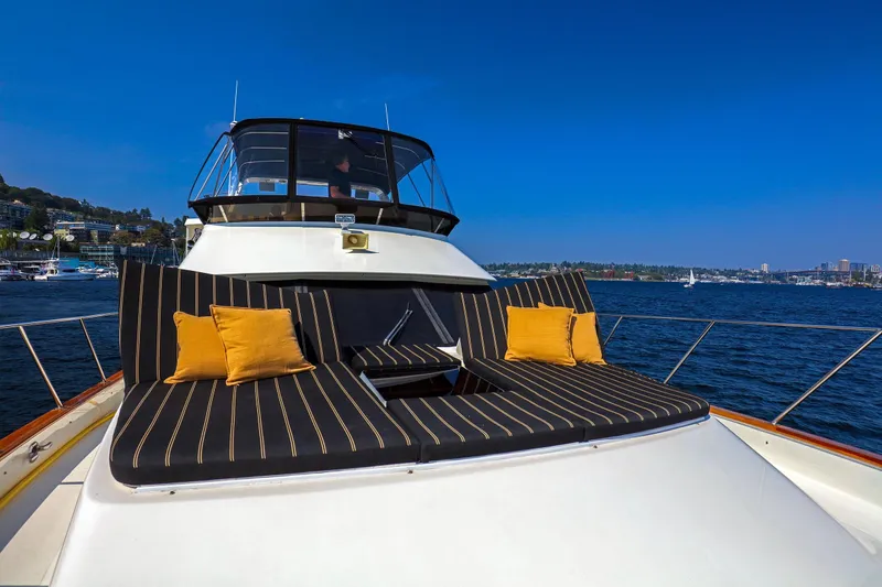 Slide: The Image of 1987 Ocean Alexander Motoryacht with striped cushions and pillows on deck, cruising on a sunny day. - 3