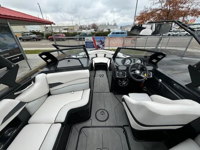 Slide: The Image of 2018 Axis A22 boat interior with white seating and modern dashboard. - 13