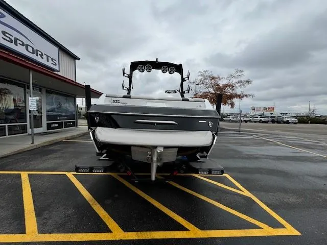 Slide: The Image of 2018 Axis A22 boat parked outside dealership on a cloudy day. - 5