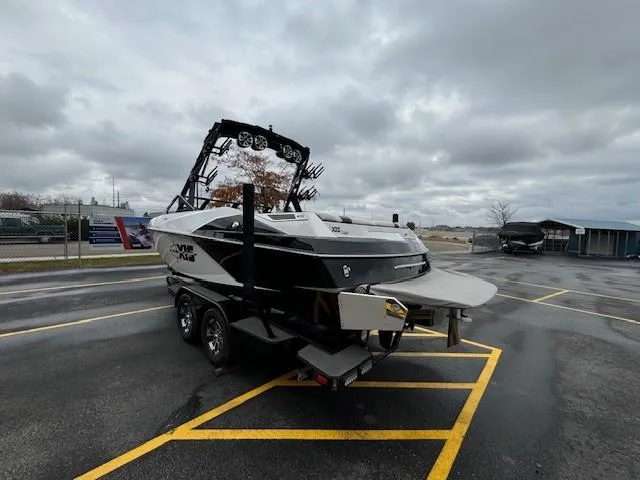 Slide: The Image of 2018 Axis A22 boat on trailer in parking lot under cloudy sky. - 6