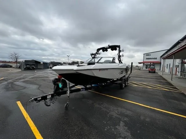 Slide: The Image of 2018 Axis A22 boat on trailer in parking lot, overcast sky. - 8