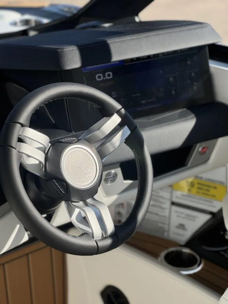 Slide: The Image of 2025 Nautique Super Air Nautique G25 steering wheel and dashboard close-up. - 14