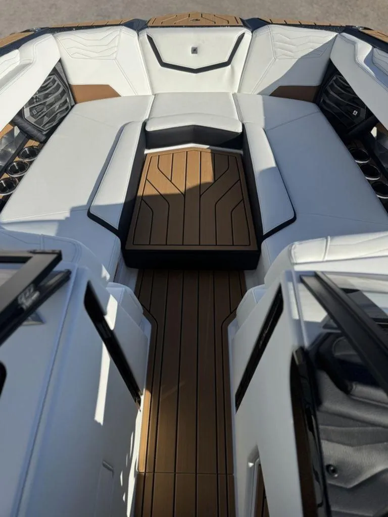 Slide: The Image of 2025 Nautique Super Air Nautique G25 interior with white seating and wood accents. - 17
