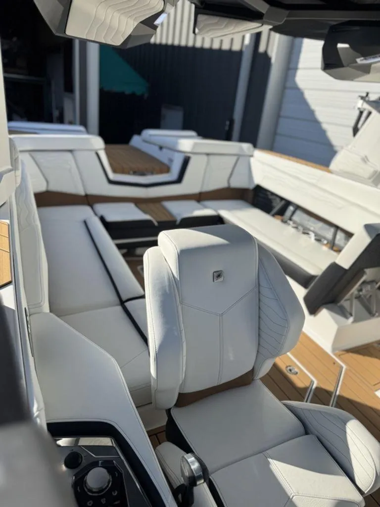 Slide: The Image of 2025 Nautique Super Air Nautique G25 interior with luxurious white seating and modern design. - 21