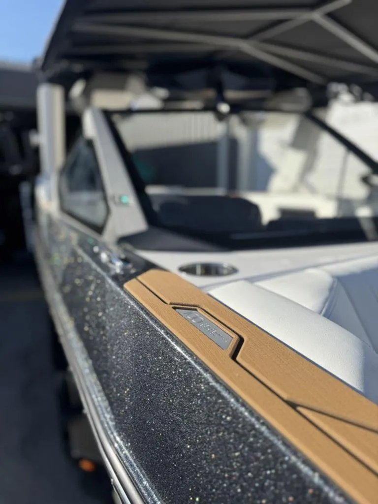 Slide: The Image of 2025 Nautique Super Air Nautique G25 boat with sleek design and luxurious interior. - 23