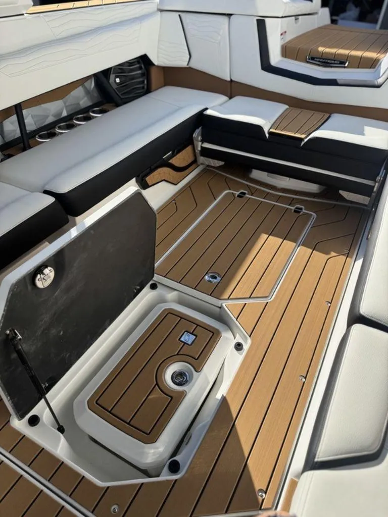 Slide: The Image of 2025 Nautique Super Air Nautique G25 interior with sleek seating and storage compartments. - 25