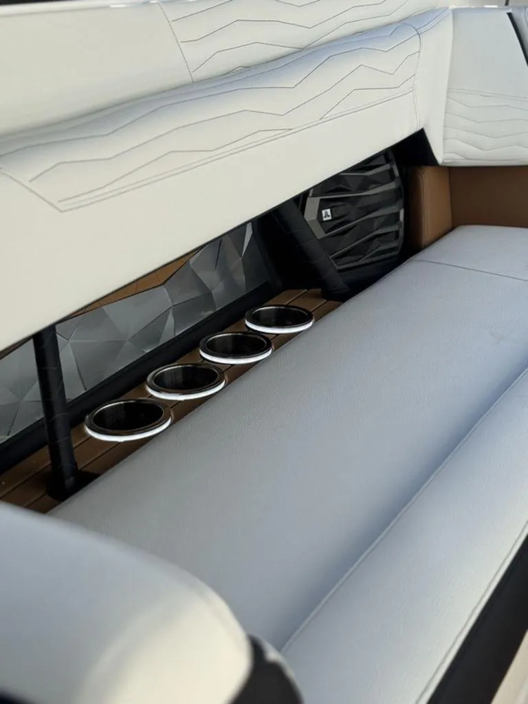 Slide: The Image of 2025 Nautique Super Air Nautique G25 interior with sleek seating and cup holders. - 6