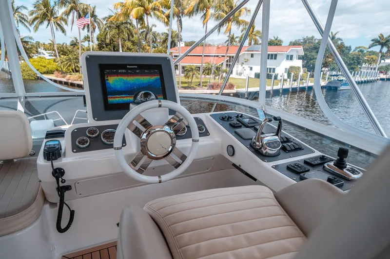 Slide: The Image of Azimut Magellano 53 yacht helm with navigation system, 2018 model, docked near palm trees. - 12