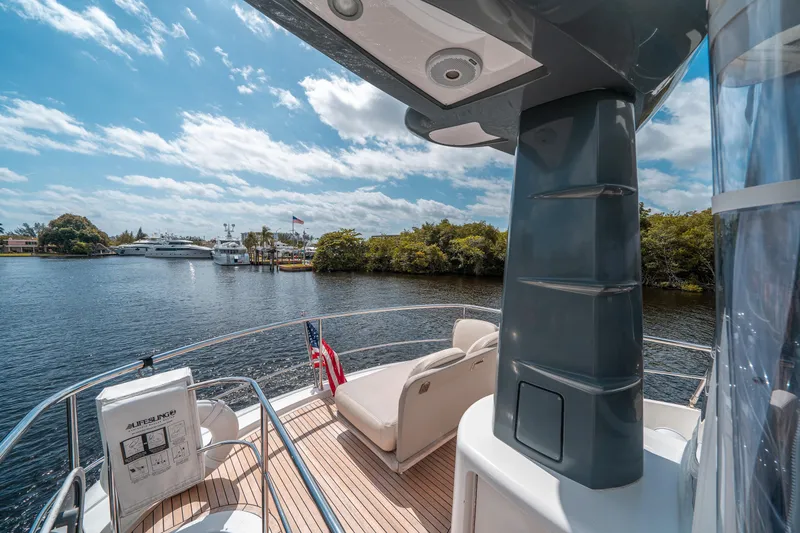 Slide: The Image of Azimut Magellano 53 yacht deck, 2018 model, with scenic waterway view. - 15