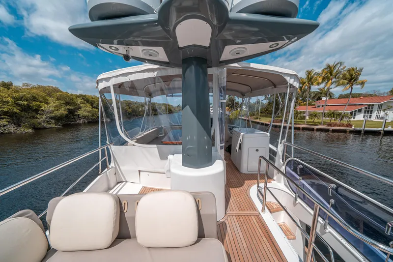 Slide: The Image of Azimut Magellano 53 yacht deck, 2018 model, featuring luxurious seating and scenic waterway view. - 19