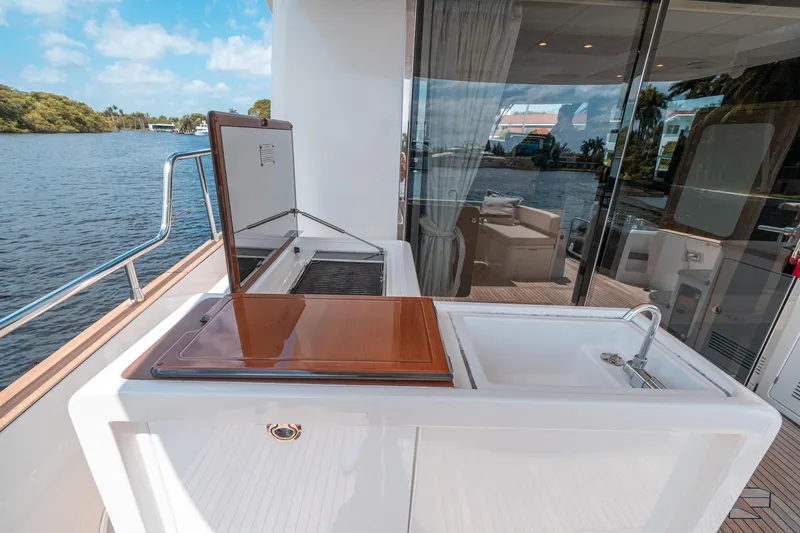 Slide: The Image of Outdoor kitchen on 2018 Azimut Magellano 53 yacht with sink and grill by the water. - 25