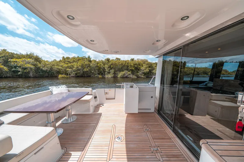 Slide: The Image of Luxurious 2018 Azimut Magellano 53 yacht deck with elegant seating and scenic water view. - 26