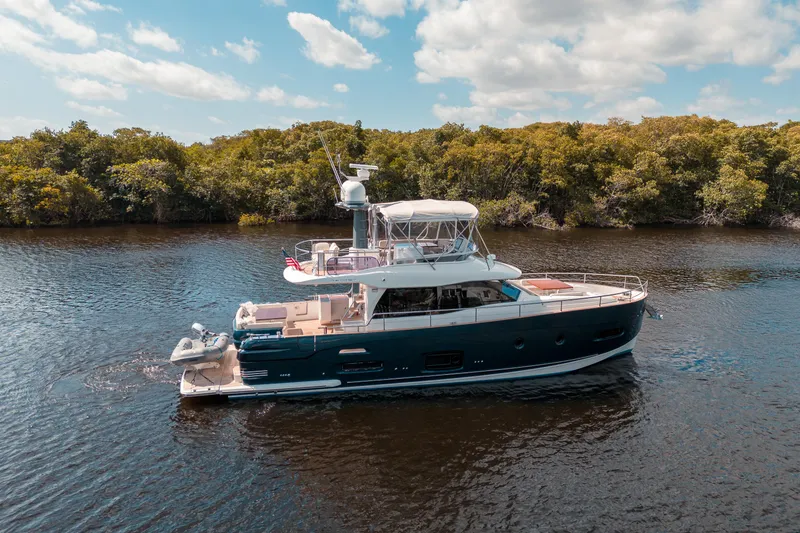 Slide: The Image of 2018 Azimut Magellano 53 yacht cruising on a serene river. - 3