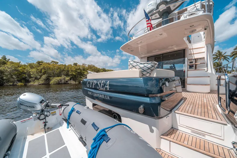 Slide: The Image of Azimut Magellano 53 yacht, 2018 model, docked with inflatable boat, sunny day, scenic view. - 34