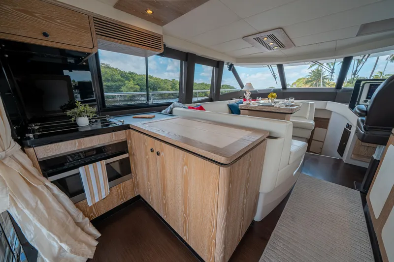 Slide: The Image of Interior of 2018 Azimut Magellano 53 yacht with modern kitchen and dining area. - 49