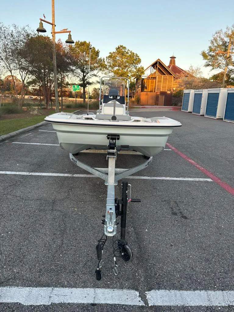 Slide: The Image of 2025 Mako Pro Skiff 15 CC boat on trailer in parking lot. - 3