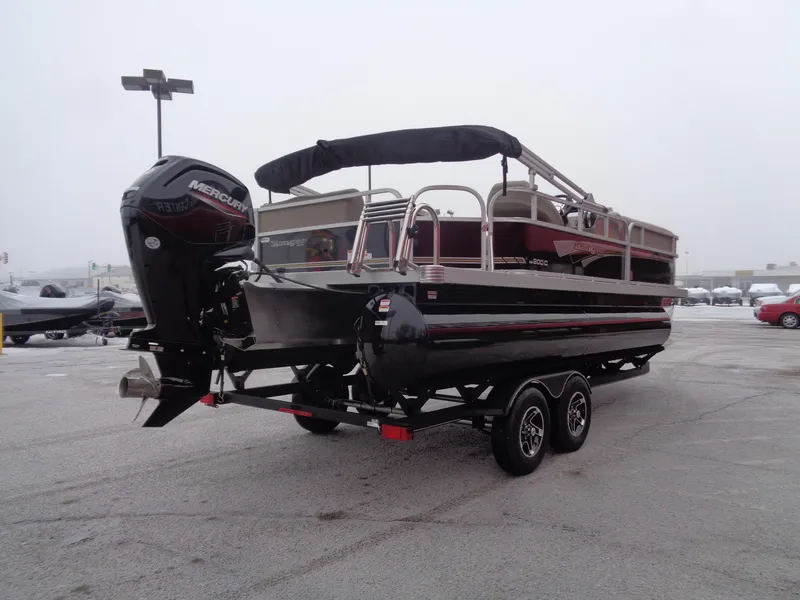 Slide: The Image of 2023 Ranger Reata 200C pontoon boat on trailer, featuring a Mercury outboard motor. - 39
