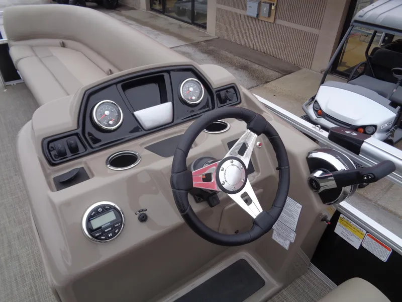 Slide: The Image of 2023 Ranger Reata 200C boat dashboard with steering wheel and gauges. - 4