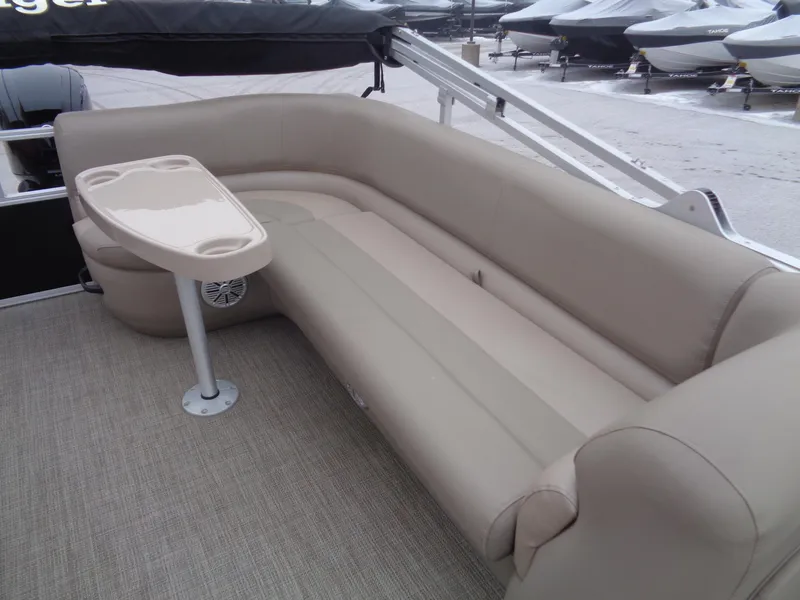 Slide: The Image of 2023 Ranger Reata 200C boat interior with beige seating and table. - 45